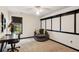 Bedroom with accent wall, desk, chair, stylish lamp and a large window with natural light at 1283 Hada Ct, Lawrenceville, GA 30043