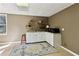 Cozy kitchenette boasts ample counter space, white cabinetry, a microwave and shelving at 1283 Hada Ct, Lawrenceville, GA 30043