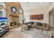 Cozy living room with stone fireplace, wood mantel, and comfortable sectional sofa at 1283 Hada Ct, Lawrenceville, GA 30043