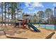 Community playground featuring colorful play equipment and mature trees, perfect for Gathering fun and outdoor activities at 1283 Hada Ct, Lawrenceville, GA 30043