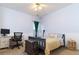 Bedroom featuring a bed, desk, woven basket, ceiling fan, and neutral-colored walls for a cozy retreat at 2250 Snug Ne Hbr, Marietta, GA 30066