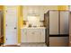 Well-lit kitchen with white cabinetry, stainless steel refrigerator, and wood floors for a clean and modern look at 2250 Snug Ne Hbr, Marietta, GA 30066