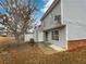 View of the home's backyard with siding and a small patio area, plus a tree at 3153 Kingswood Gln, Decatur, GA 30034