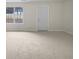 Spacious living room featuring a bright sunny day through the window and neutral colored walls at 3153 Kingswood Gln, Decatur, GA 30034