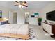 Serene main bedroom featuring a king bed, a ceiling fan, and a view into the main bathroom at 3153 Kingswood Gln, Decatur, GA 30034