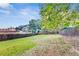 Wide view of a big backyard featuring a playground with a slide, a grass area and a wooden fence at 3580 S Sherwood Se Rd, Smyrna, GA 30082