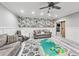 Bright basement living area with wood-look floors, board and batten, stylish wallpaper and comfortable seating at 3580 S Sherwood Se Rd, Smyrna, GA 30082