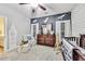 Cozy Bedroom with a celestial-themed accent wall, dresser, chair, and crib at 3580 S Sherwood Se Rd, Smyrna, GA 30082