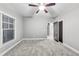 A comfortable bedroom with soft carpet, ceiling fan, and natural light from a window at 3580 S Sherwood Se Rd, Smyrna, GA 30082