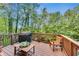 Outdoor deck with grill and wooded views, perfect for relaxing and entertaining at 3580 S Sherwood Se Rd, Smyrna, GA 30082