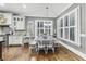 Bright dining room features beautiful hardwood floors, large windows with shutters, and white trim at 3580 S Sherwood Se Rd, Smyrna, GA 30082