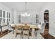 Elegant dining room featuring wood floors, modern chandelier, and wainscoting at 3580 S Sherwood Se Rd, Smyrna, GA 30082