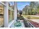 Cozy porch with wrought iron railing and space for an outdoor table and chairs, overlooking the lawn at 3580 S Sherwood Se Rd, Smyrna, GA 30082