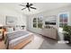 Bright bedroom with two windows, neutral décor, and modern furniture, virtually staged at 11403 S Grove Dr, Hampton, GA 30228
