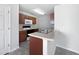 Efficient kitchen with stainless steel sink, white countertop, and stained wood cabinets at 11403 S Grove Dr, Hampton, GA 30228