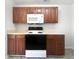 Kitchen featuring wooden cabinets and black and white appliances at 11403 S Grove Dr, Hampton, GA 30228
