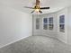 Bright living room featuring a ceiling fan, plenty of natural light from bay windows, and neutral paint at 11403 S Grove Dr, Hampton, GA 30228