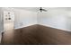 Spacious living room with dark wood-look flooring and ceiling fan at 11403 S Grove Dr, Hampton, GA 30228