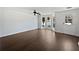 A well-lit living room featuring beautiful hardwood floors, and large windows at 11403 S Grove Dr, Hampton, GA 30228