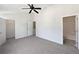 Bright main bedroom with carpet, three doors, neutral walls, and ceiling fan at 11403 S Grove Dr, Hampton, GA 30228