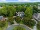 Aerial view of a home nestled amongst lush trees in a residential neighborhood at 1416 Elgin Way, Cumming, GA 30041