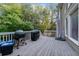 Spacious back deck with lush greenery, an outdoor kitchen, and plenty of room to entertain at 1416 Elgin Way, Cumming, GA 30041