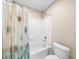 Bathroom featuring a white tub with shower, patterned shower curtain, and white tiled walls at 1416 Elgin Way, Cumming, GA 30041