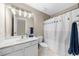 Bathroom featuring a vanity, mirror with lighting, toilet, and shower with a decorative curtain at 1416 Elgin Way, Cumming, GA 30041