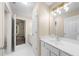 Bright bathroom featuring a vanity, mirror with lighting, and an open doorway at 1416 Elgin Way, Cumming, GA 30041