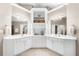 Bright bathroom featuring double sinks, vanity cabinets, and a central storage cabinet at 1416 Elgin Way, Cumming, GA 30041