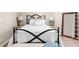 Bedroom featuring neutral-colored walls, carpet, and an iron bed frame with decorative lamps at 1416 Elgin Way, Cumming, GA 30041