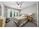 Cozy bedroom featuring neutral walls, plush carpet, and bright natural light from the large window at 1416 Elgin Way, Cumming, GA 30041