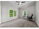 Bedroom featuring two windows offering natural light, carpeted floors, and a high ceiling at 1416 Elgin Way, Cumming, GA 30041