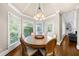 Bright dining room with a round table, multiple windows and access to the living area at 1416 Elgin Way, Cumming, GA 30041