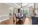 Formal dining room featuring hardwood floors, neutral paint, and an arched entryway into the foyer at 1416 Elgin Way, Cumming, GA 30041