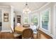 Charming dining room featuring a round wood table, a decorative light fixture, and natural light at 1416 Elgin Way, Cumming, GA 30041