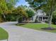 Charming two-story home with a well-manicured lawn and a long driveway leading to the garage at 1416 Elgin Way, Cumming, GA 30041