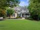 Beautiful two-story home with a covered front porch and a perfectly manicured lawn at 1416 Elgin Way, Cumming, GA 30041