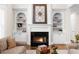 Living room fireplace with white mantle, decorative art piece, and flanking built-in cabinets at 1416 Elgin Way, Cumming, GA 30041