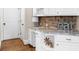 Kitchen featuring an eat-in countertop and stone backsplash at 1416 Elgin Way, Cumming, GA 30041