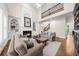 Spacious living room with fireplace, built-in shelving, and a view of the upper level at 1416 Elgin Way, Cumming, GA 30041