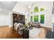 Bright living room featuring high ceilings, large arched windows, and built-in bookcase at 1416 Elgin Way, Cumming, GA 30041