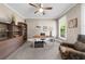 Bright home office with neutral walls, comfortable chair, a ceiling fan and built-in shelving at 1416 Elgin Way, Cumming, GA 30041