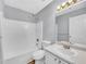 Bathroom boasts a vanity with mirror, tub/shower combo, and tiled flooring at 1681 Graystone Dr, Hampton, GA 30228