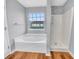 Bathroom showcases tub, separate shower, and a large window overlooking the yard at 1681 Graystone Dr, Hampton, GA 30228