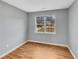 Neutral bedroom with hardwood flooring, a large window, and gray painted walls at 1681 Graystone Dr, Hampton, GA 30228