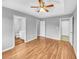 Bedroom features wood floors, a ceiling fan, and two doorways at 1681 Graystone Dr, Hampton, GA 30228