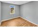 Bright bedroom with hardwood floors, gray walls, and a window overlooking the street at 1681 Graystone Dr, Hampton, GA 30228