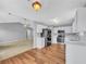 Well-lit eat-in kitchen featuring white cabinets, stainless steel appliances, and view to living area at 1681 Graystone Dr, Hampton, GA 30228