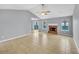 Bright living room with fireplace, vaulted ceiling, tile flooring, and sliding door to backyard at 1681 Graystone Dr, Hampton, GA 30228